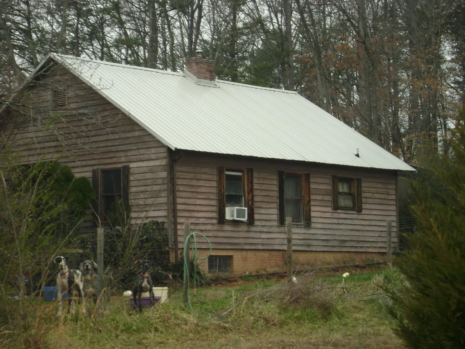 White metal roof on an old wood sided farmhouse, from a Metal Roof Installation job in Chattanooga